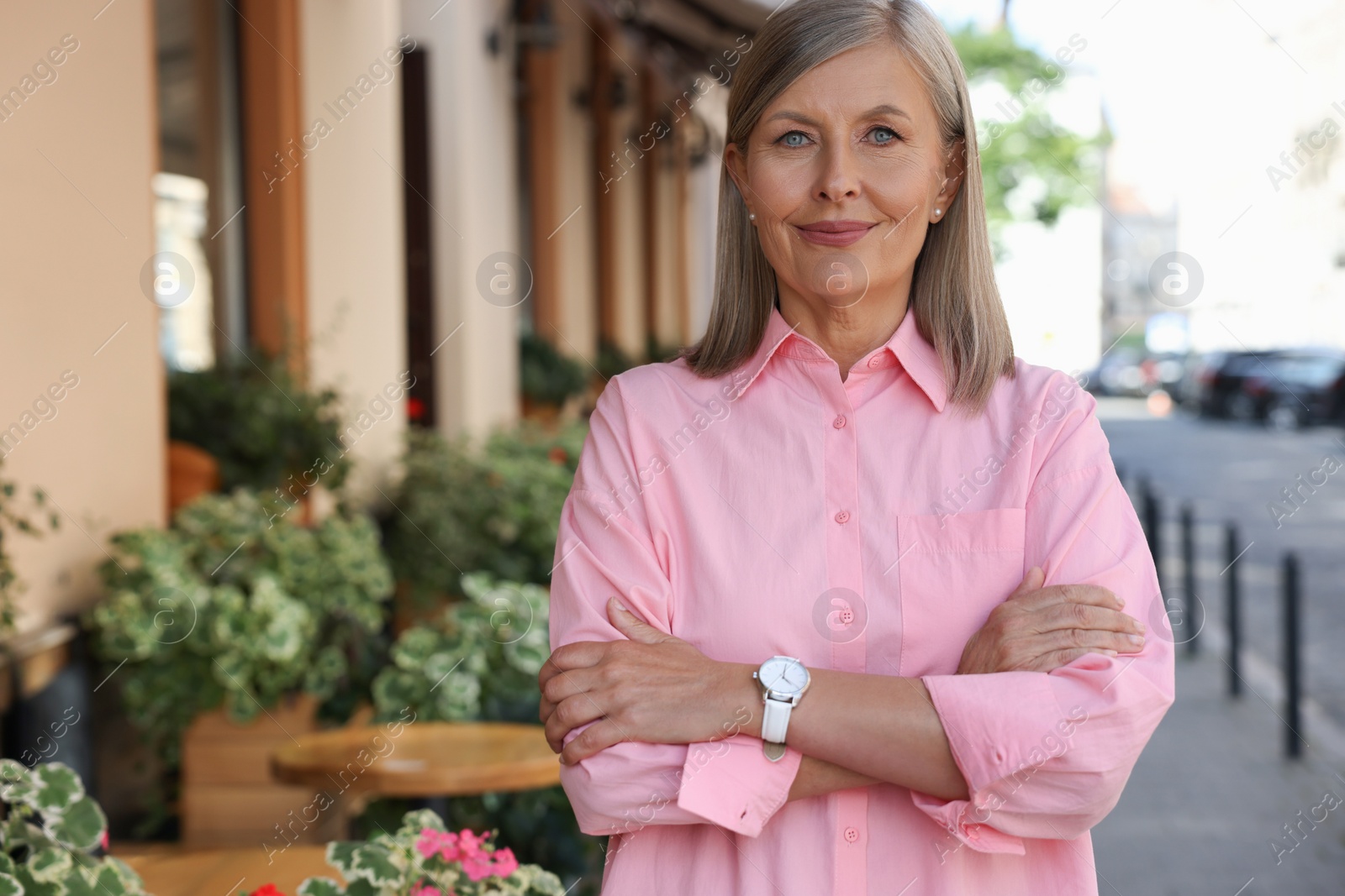 Photo of Portrait of beautiful smiling senior woman outdoors, space for text