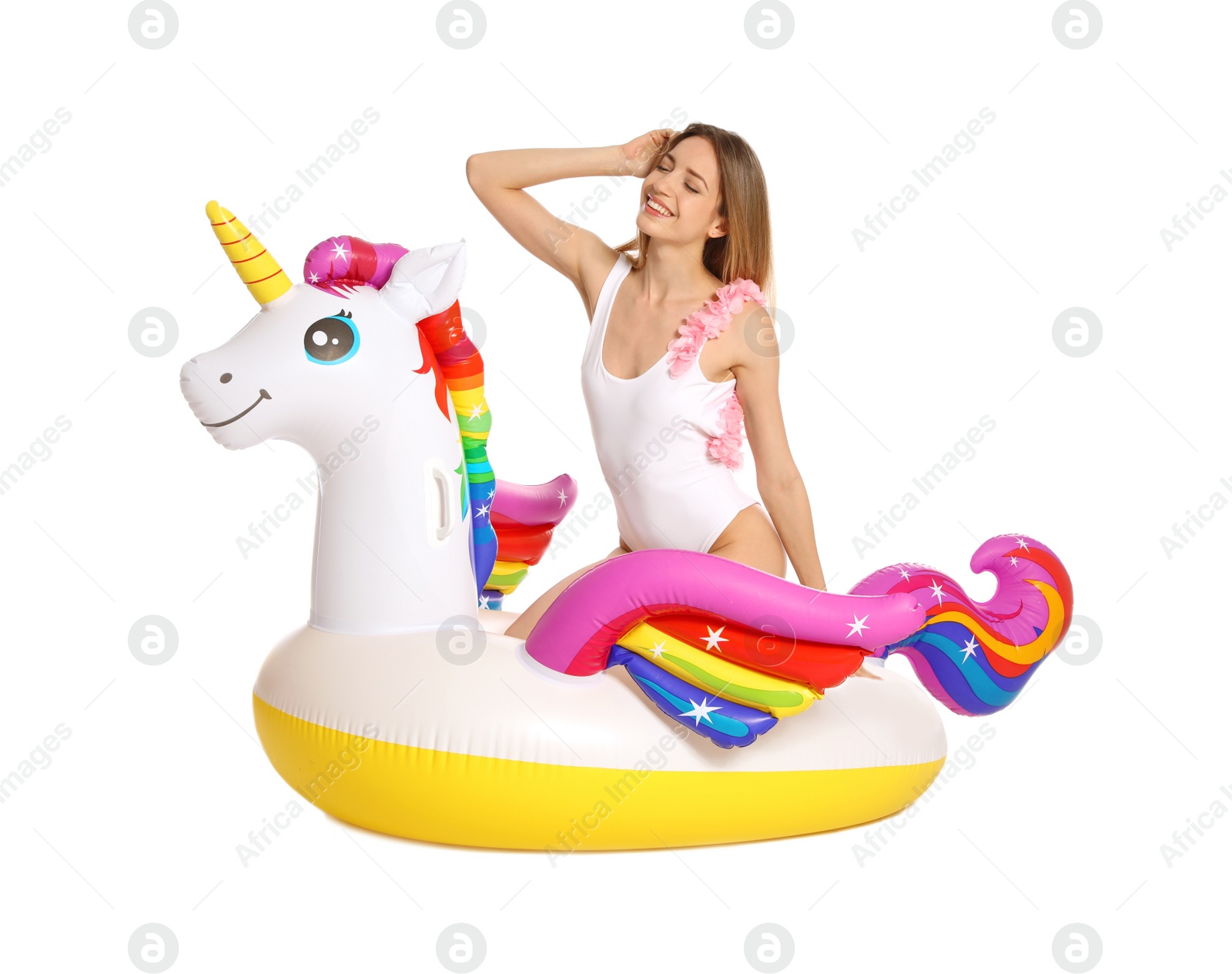 Photo of Beautiful young woman in stylish bikini with  unicorn inflatable ring on white background