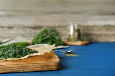 Photo of Fresh dill preparing for drying on wooden board. Space for text