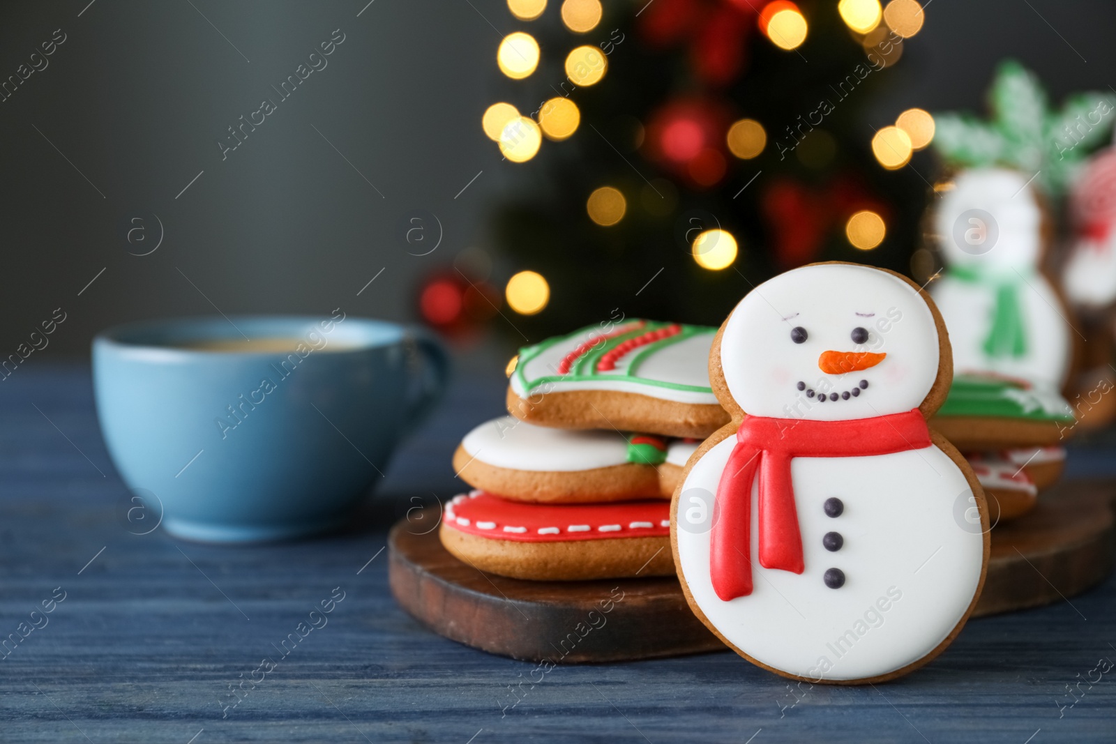 Photo of Decorated Christmas cookies on blue wooden table