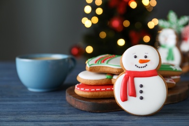 Decorated Christmas cookies on blue wooden table