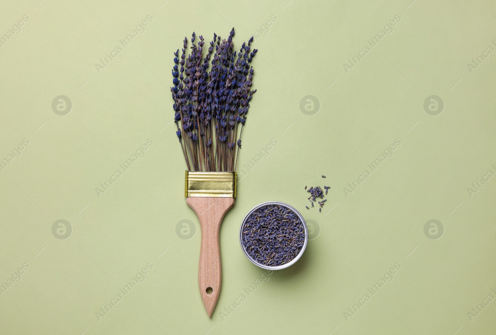 Photo of Creative flat lay composition with paint brush and lavender flowers on light green background
