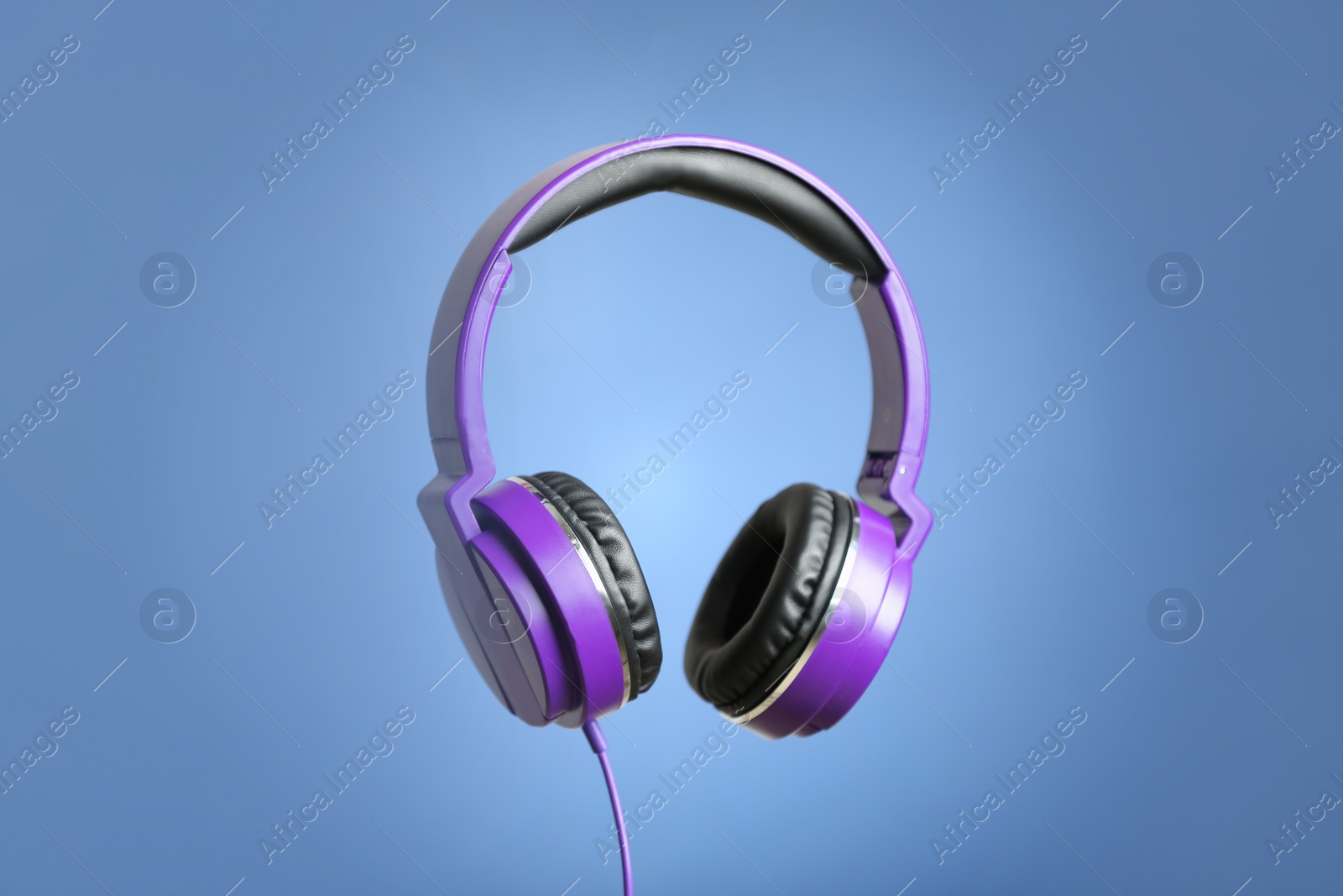 Photo of Stylish headphones with pads on color background