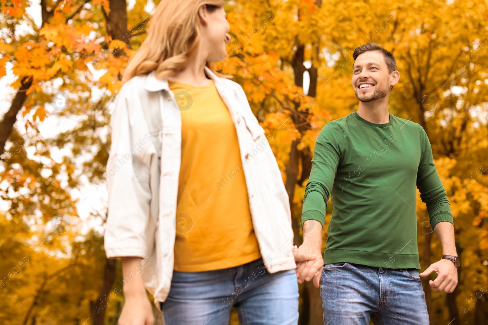 Photo of Lovely couple spending time together in park. Autumn walk