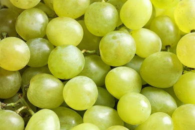 Fresh ripe juicy white grapes as background, closeup view