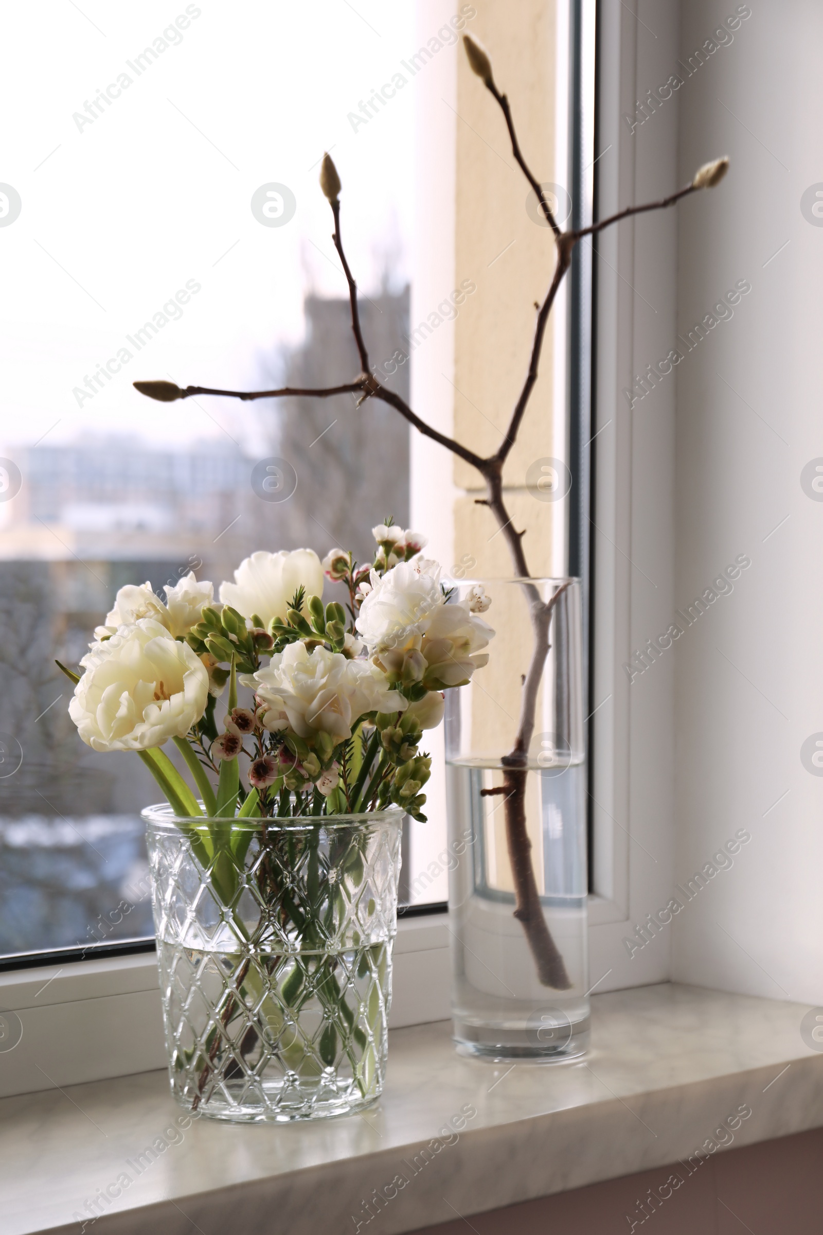 Photo of Beautiful spring flowers in vase on windowsill indoors