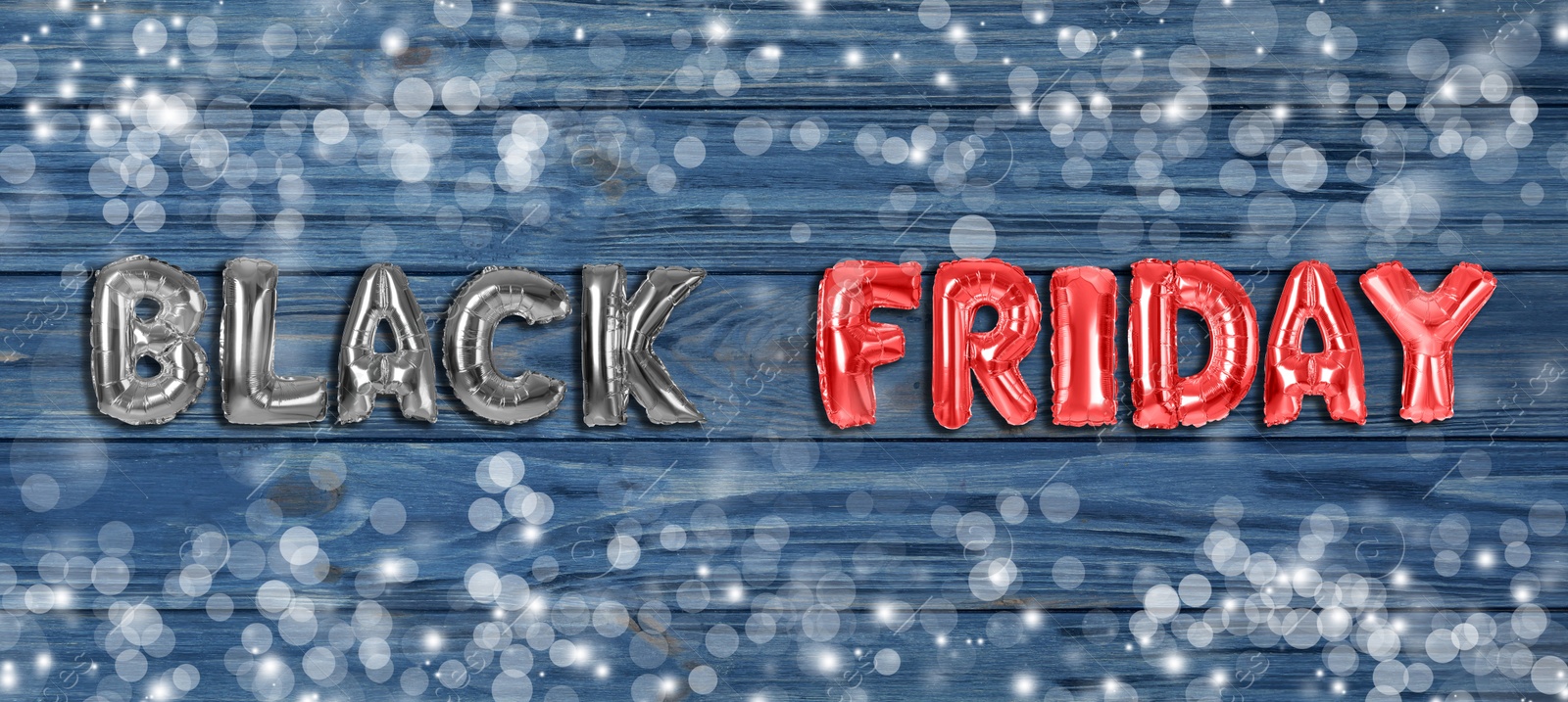 Image of Phrase BLACK FRIDAY made of foil balloon letters on blue wooden background. Banner design