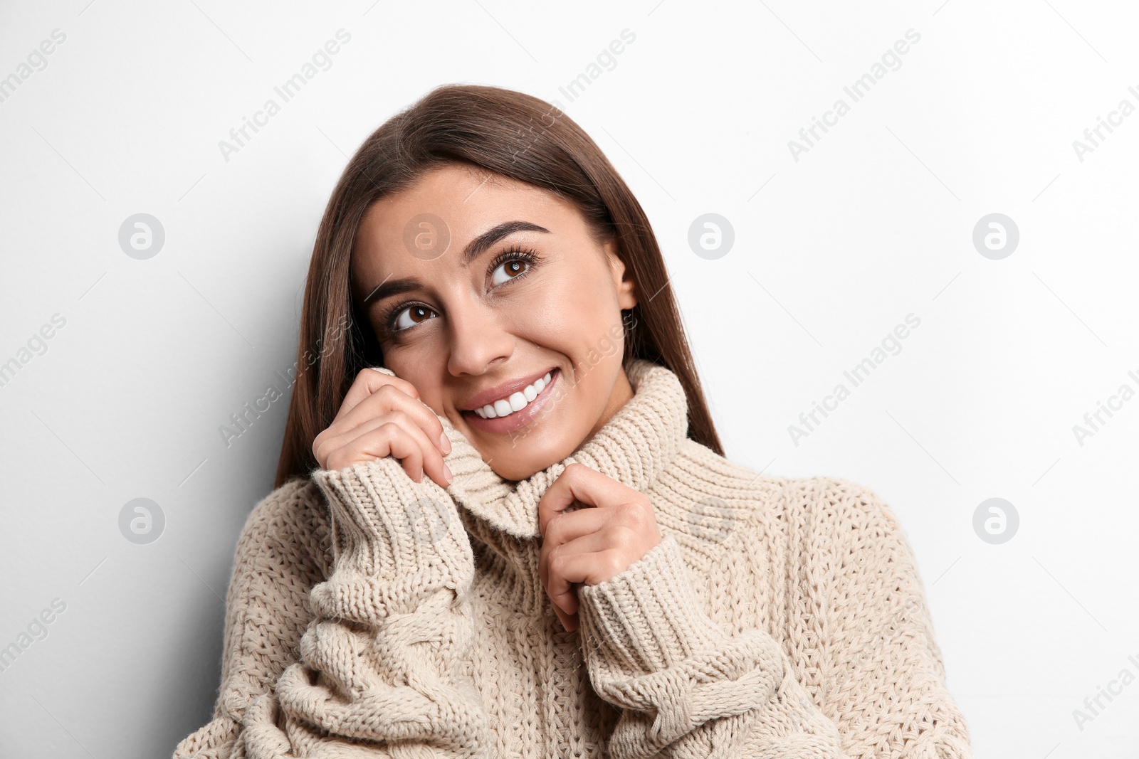 Photo of Beautiful young woman in warm sweater on white background