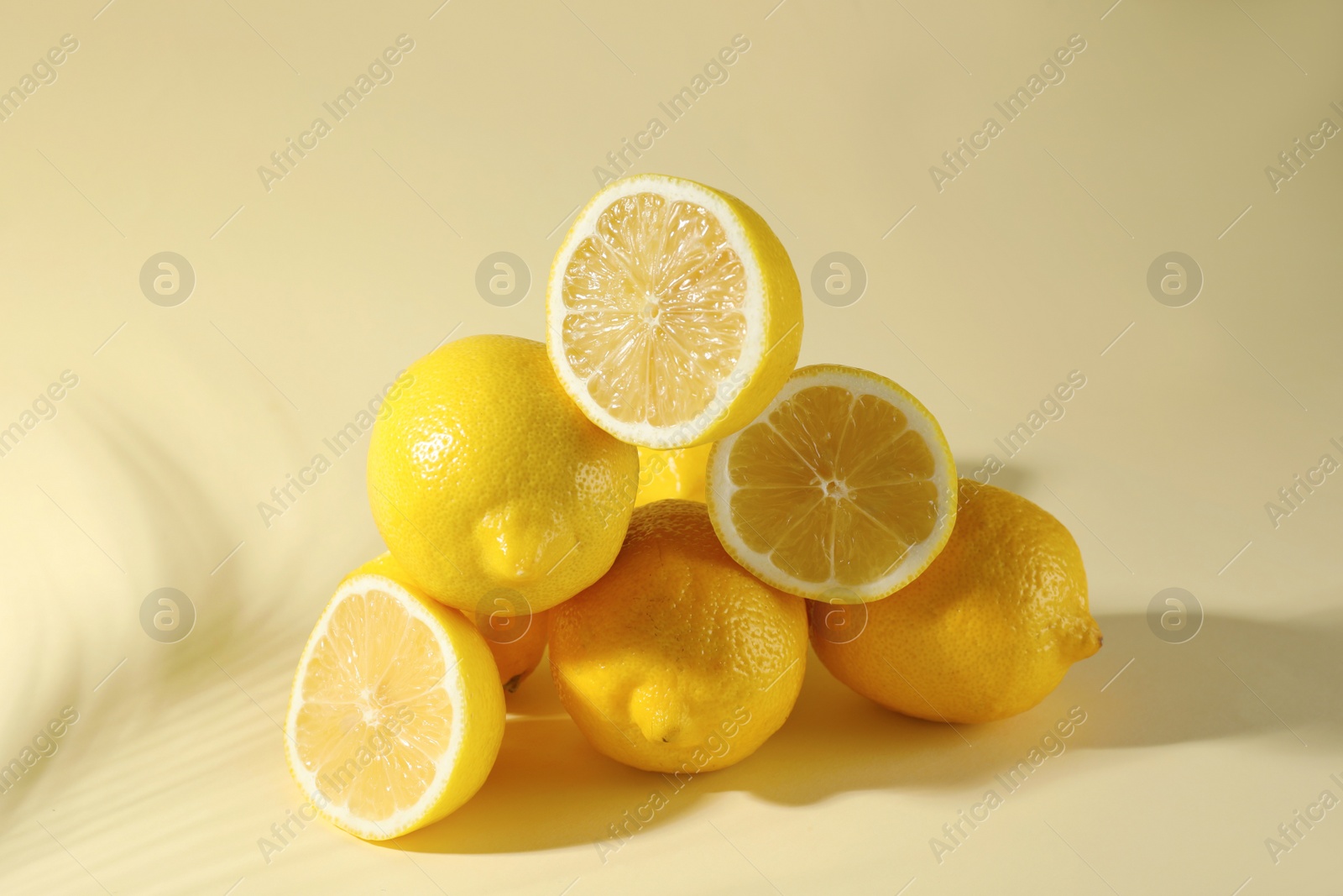 Photo of Pile of fresh lemons on light background