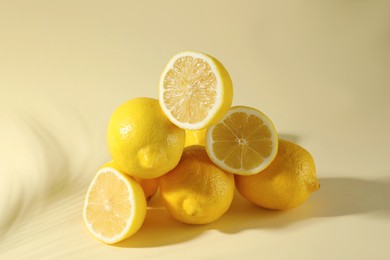 Photo of Pile of fresh lemons on light background