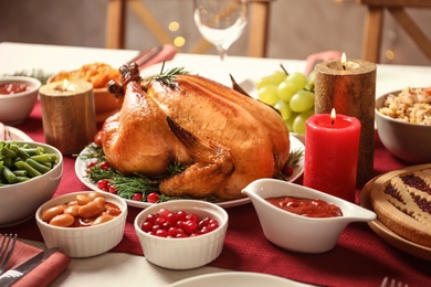 Photo of Traditional festive dinner with delicious roasted turkey served on table