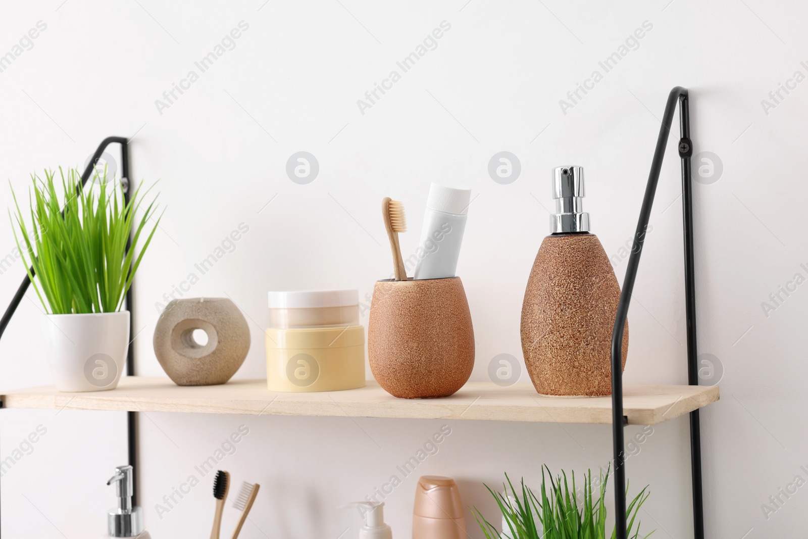 Photo of Different bath accessories, personal care products and artificial plants indoors