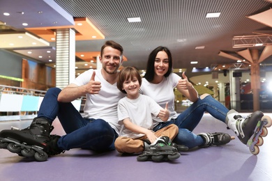 Happy family spending time at roller skating rink