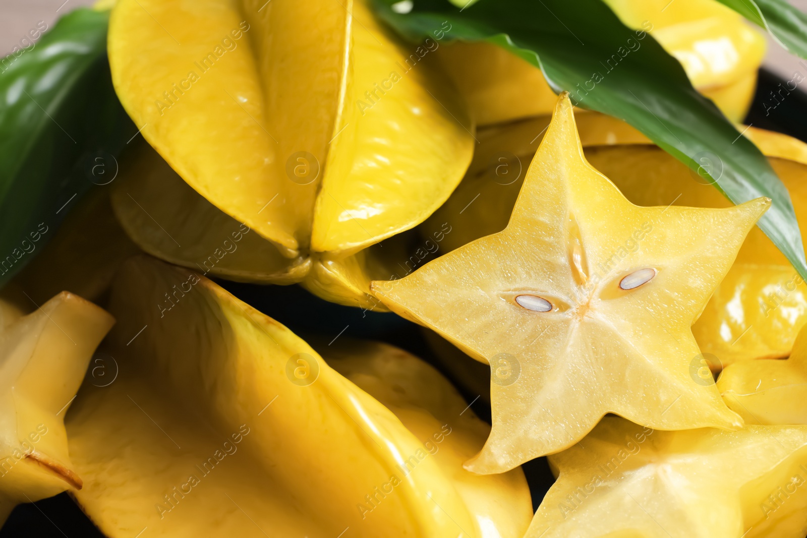 Photo of Pile of delicious fresh carambola fruits, closeup