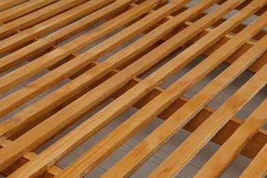 Photo of Closeup view of new wooden bed frame indoors