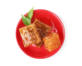 Plate with honeycomb pieces and leaves isolated on white, top view