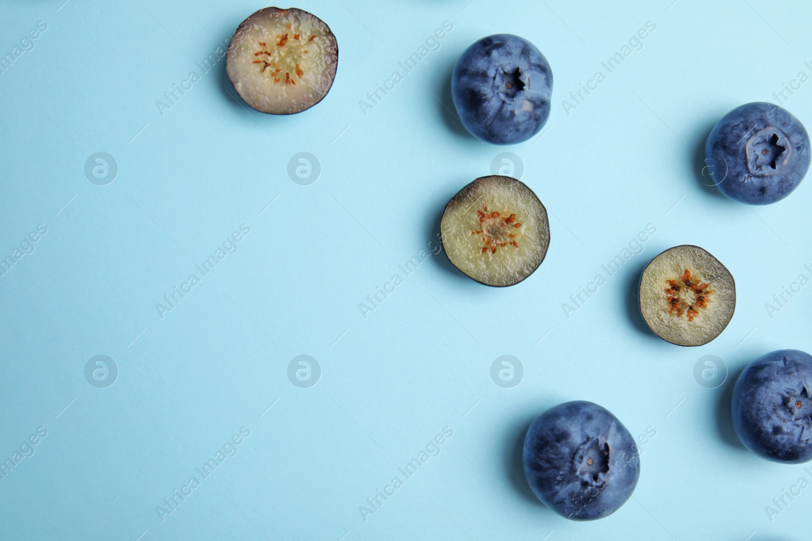 Photo of Flat lay composition with tasty blueberry and space for text on color background