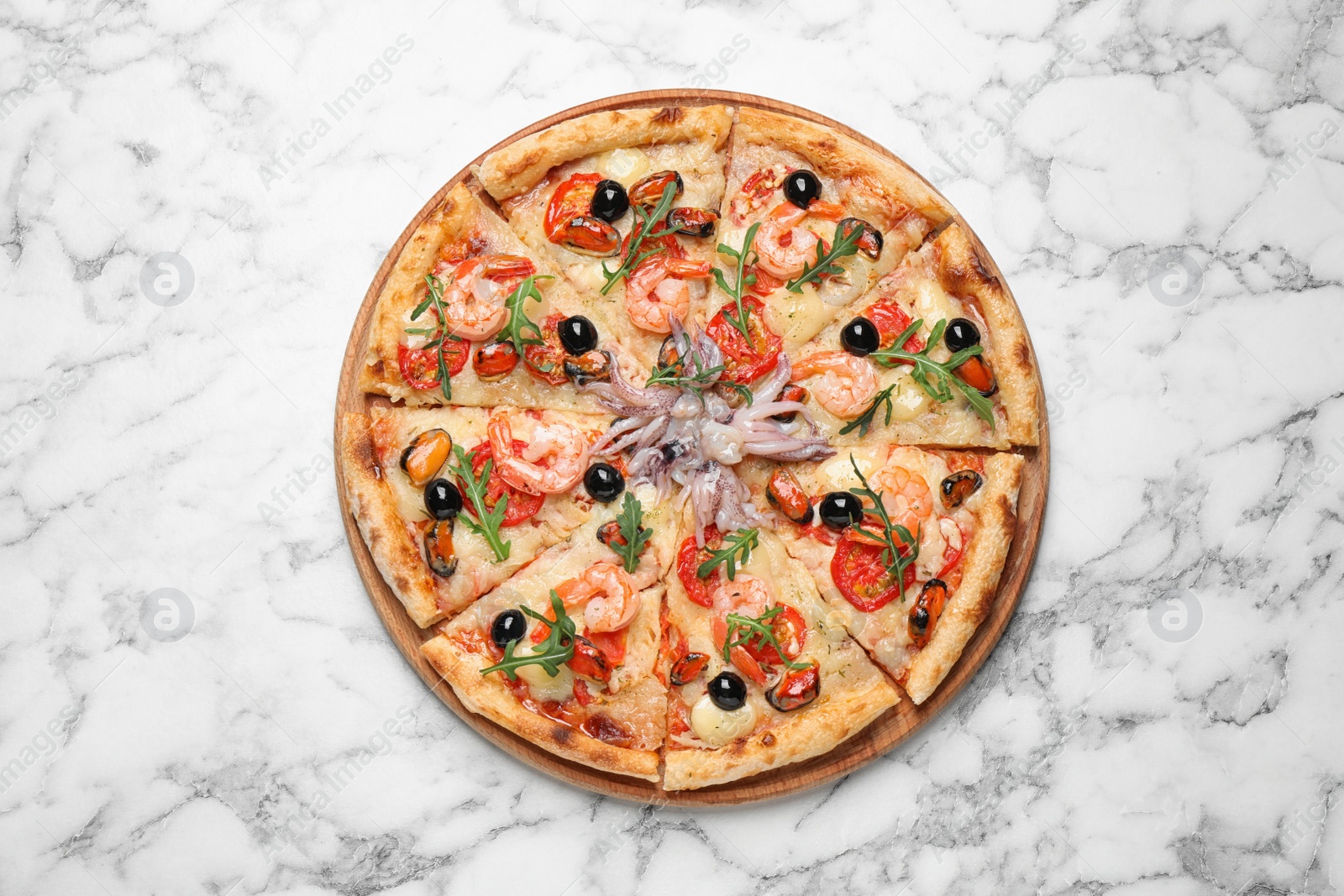 Photo of Tasty pizza with seafood on white marble table, top view