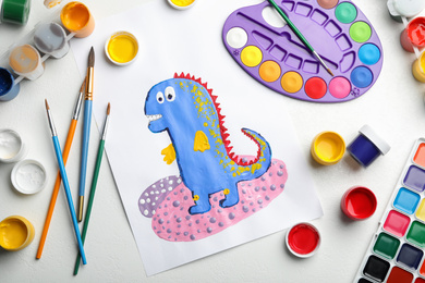 Photo of Flat lay composition with child's painting of dinosaur on white table