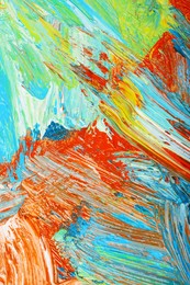 Photo of Closeup view of artist's palette with mixed bright paints as background