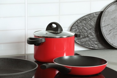 Set of clean cookware on stove in kitchen