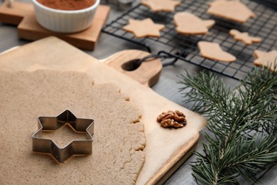 Photo of Homemade Christmas biscuits. Dough and cookie cutter on table, closeup