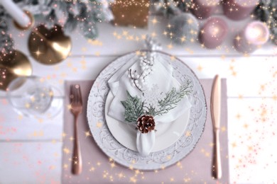Image of Christmas place setting for festive dinner on white wooden table, flat lay. Bokeh effect
