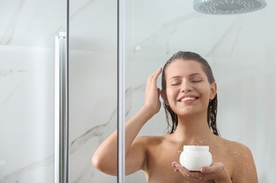 Image of Beautiful young woman applying hair mask in shower at home. Space for text