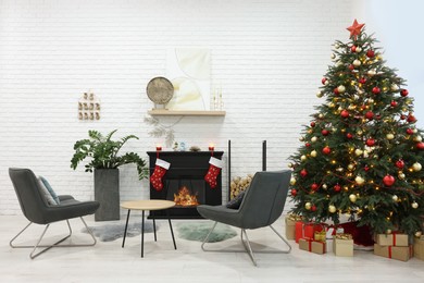 Photo of Beautiful Christmas tree near fireplace and cosy armchairs in room. Interior design