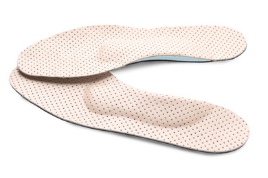 Photo of Beige comfortable orthopedic insoles isolated on white