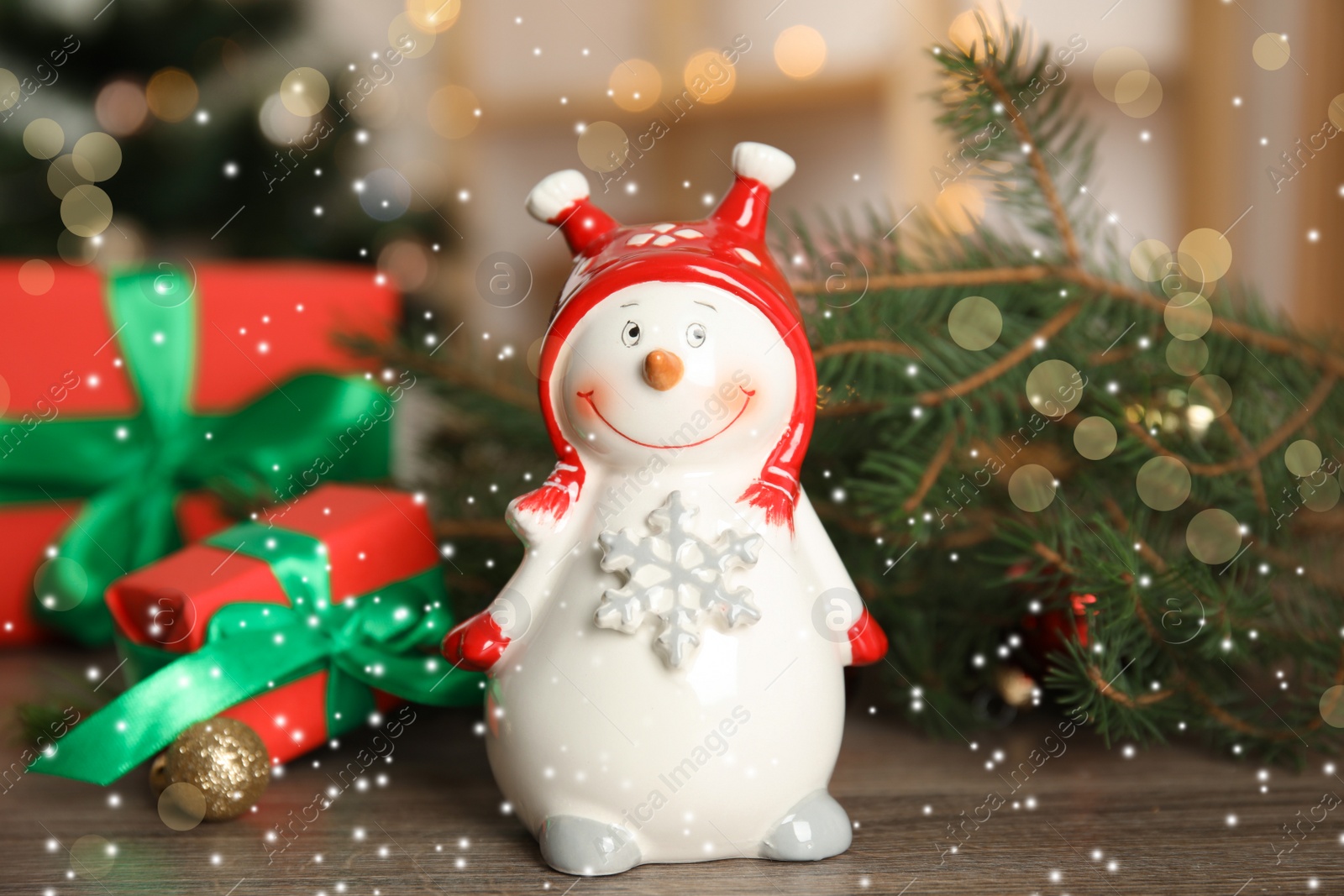 Photo of Christmas composition with decorative snowman on wooden table