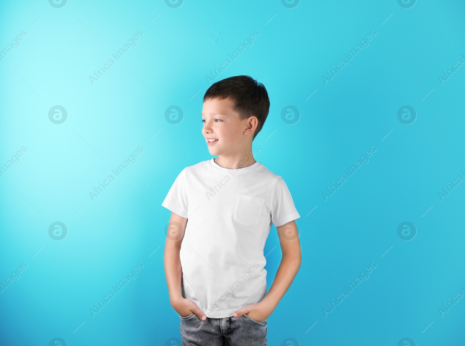 Photo of Little boy in t-shirt on color background. Mock-up for design