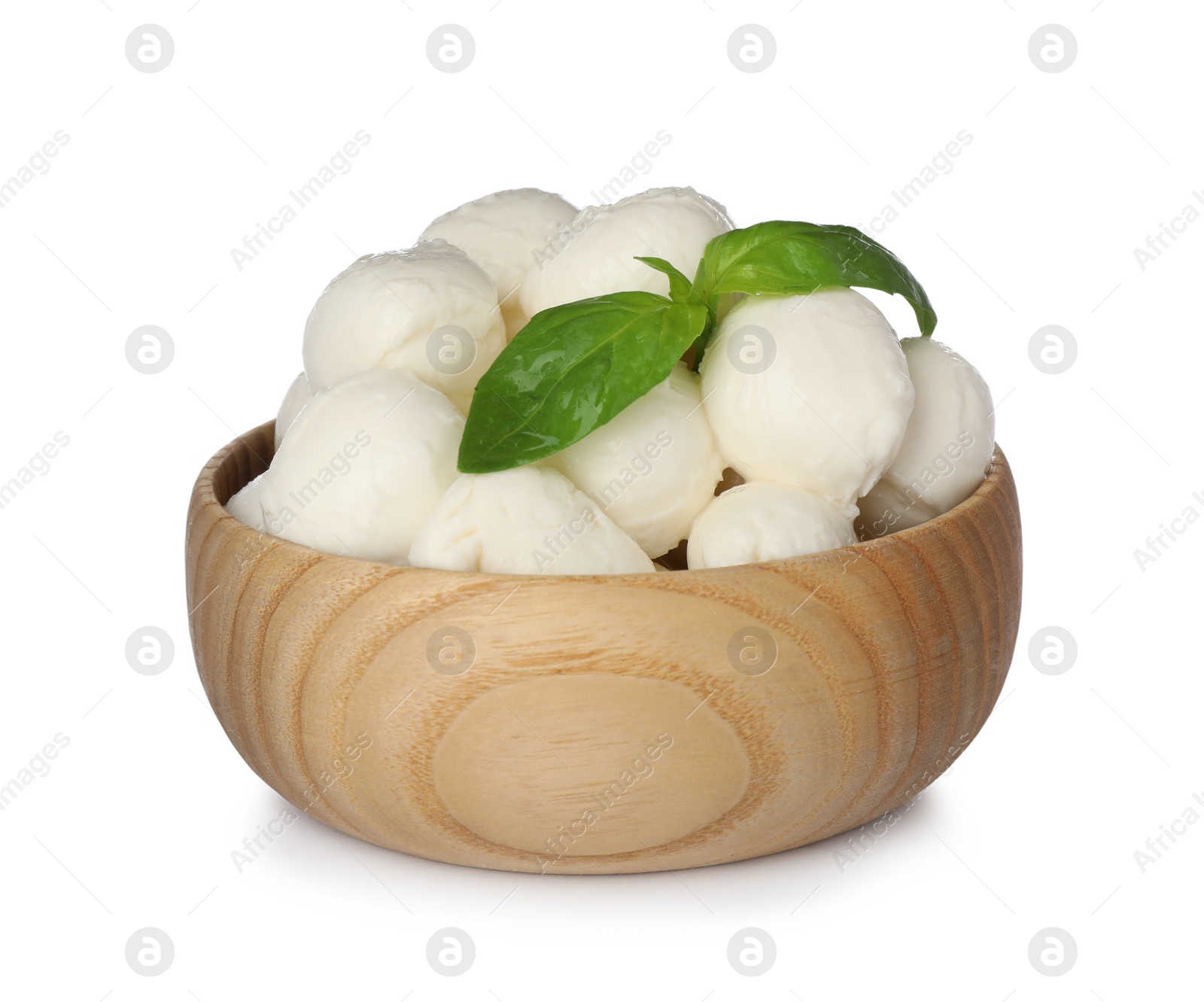 Photo of Wooden bowl with mozzarella cheese balls and basil on white background