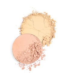 Photo of Different broken face powders on white background, top view