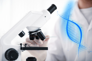 Image of Scientist with test slide and microscope in laboratory, closeup. Medical research