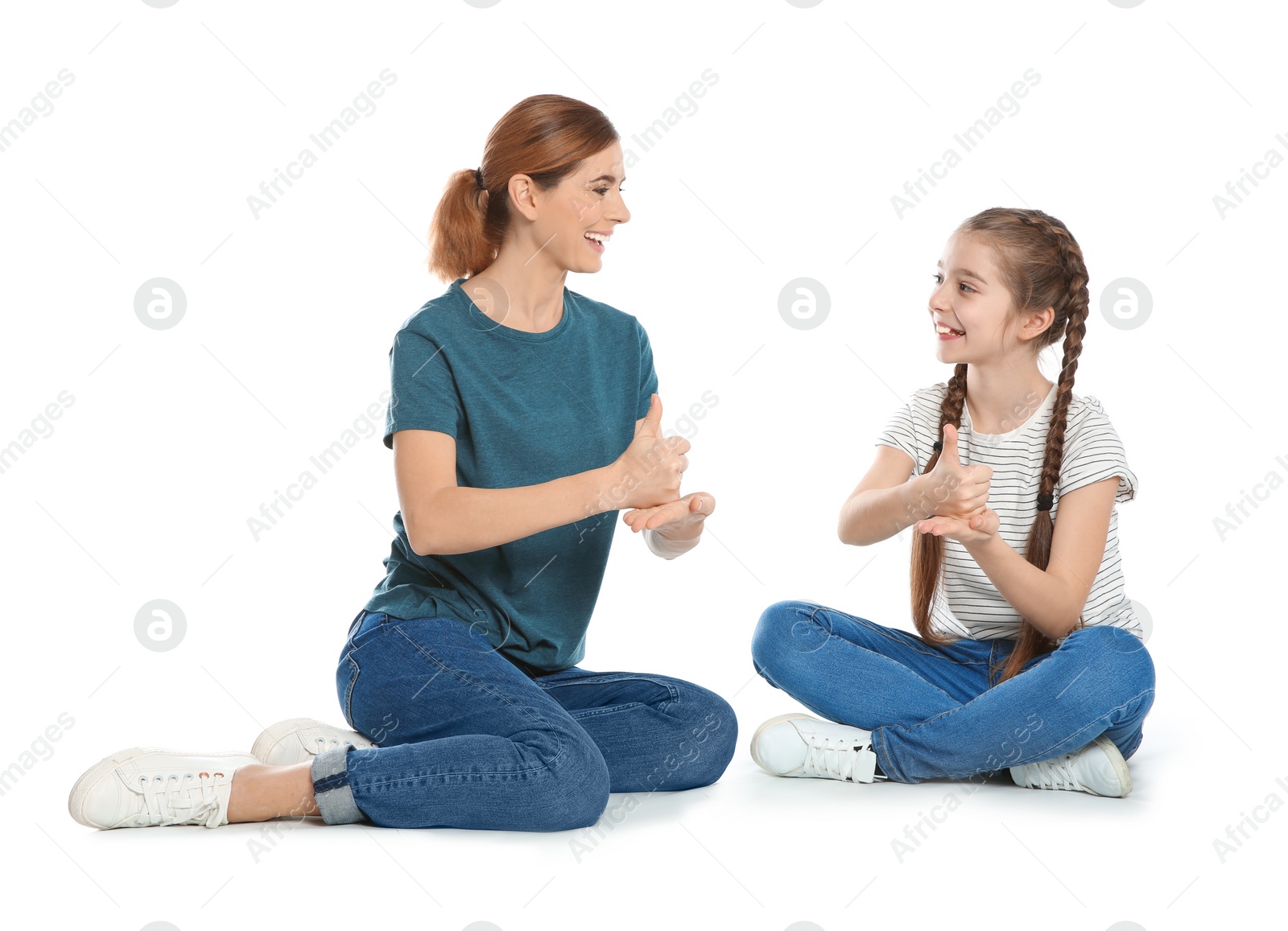 Photo of Hearing impaired mother and her child talking with help of sign language on white background