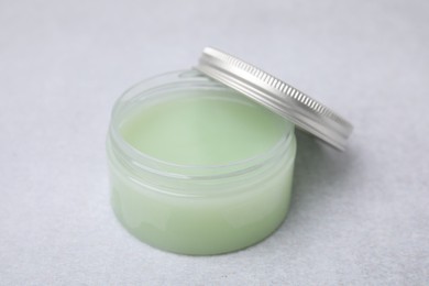 Photo of Jar of petroleum jelly on light gray background