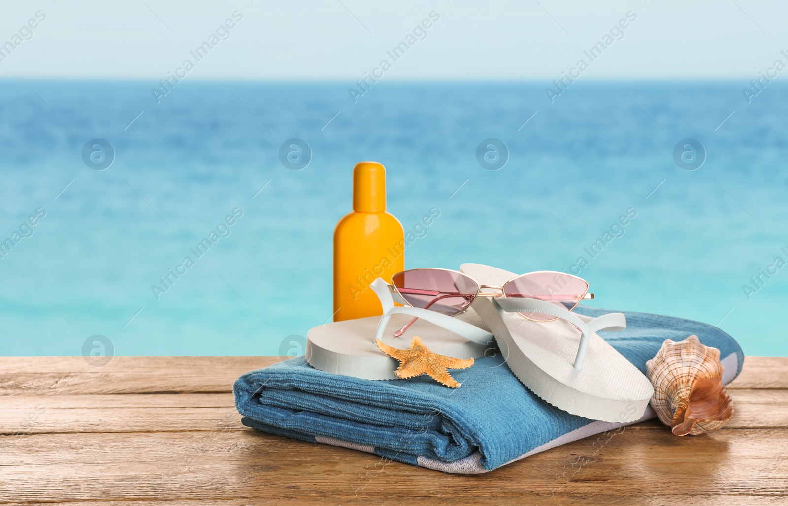 Image of Different beach objects on wooden surface near sea