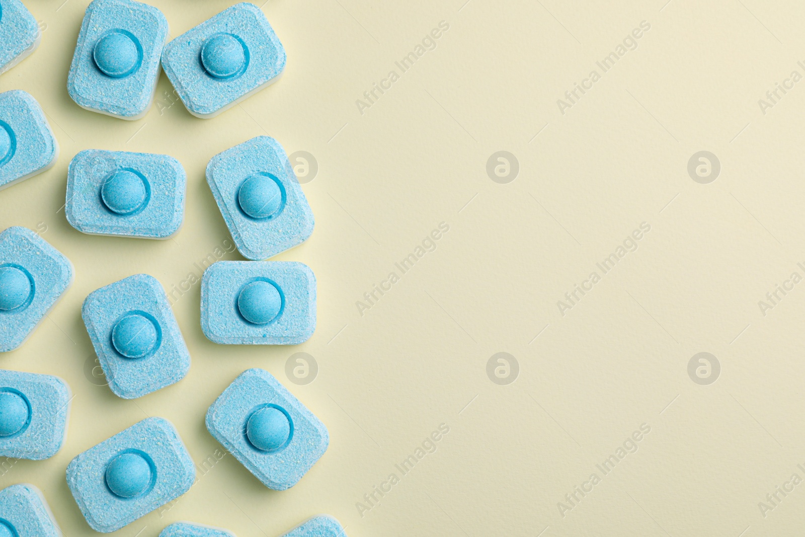 Photo of Water softener tablets on beige background, flat lay. Space for text