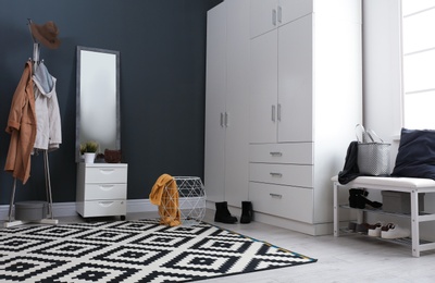 Photo of Stylish hallway interior with large mirror and wardrobe