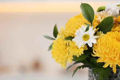 Photo of Bouquet of beautiful chrysanthemum flowers on blurred background, closeup. Space for text