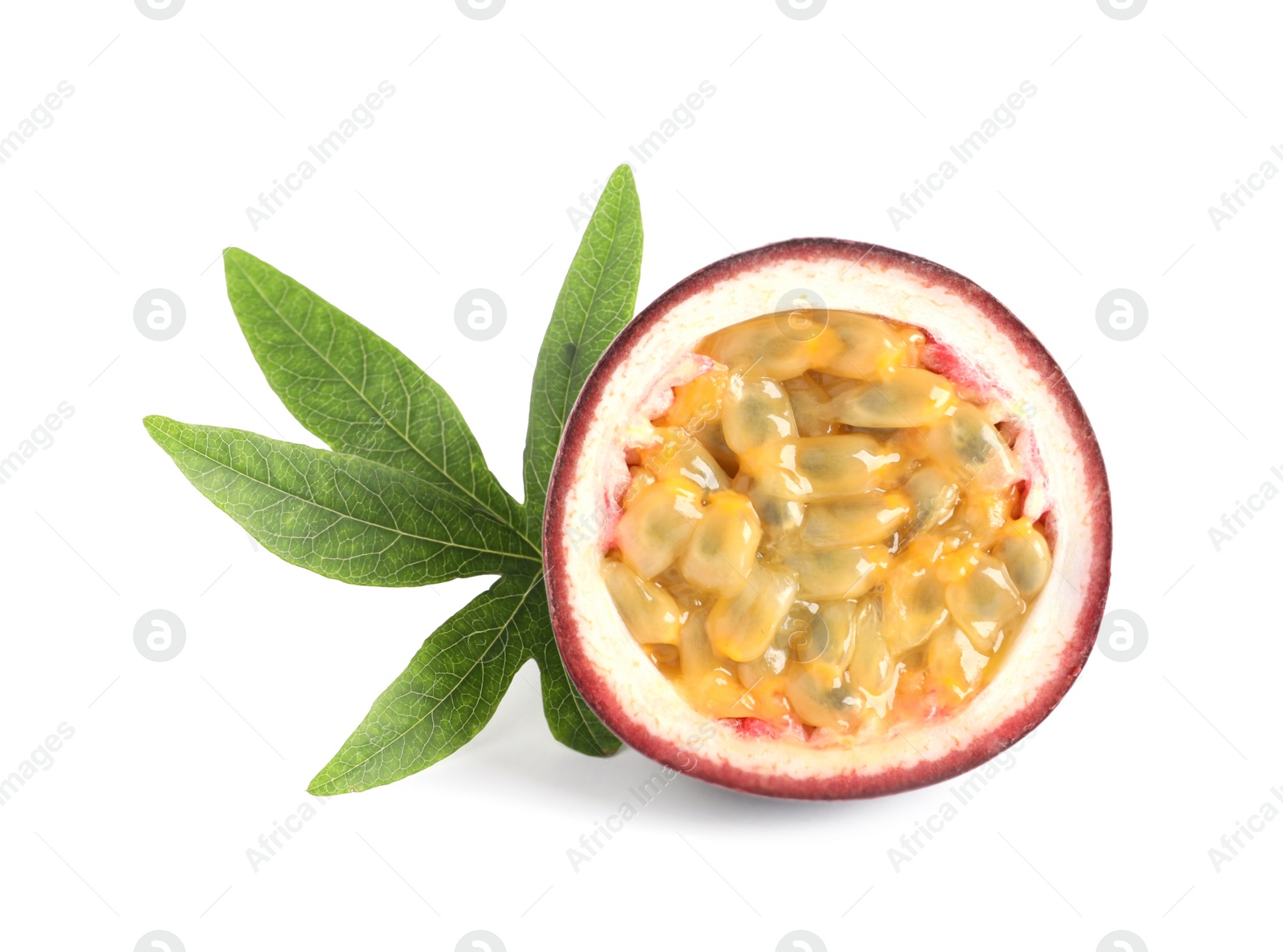 Photo of Half of ripe passion fruit with leaf isolated on white