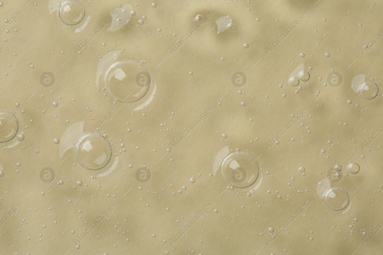 Photo of Cosmetic serum on beige background, top view