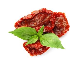 Photo of Tasty sun dried tomatoes with green leaves on white background