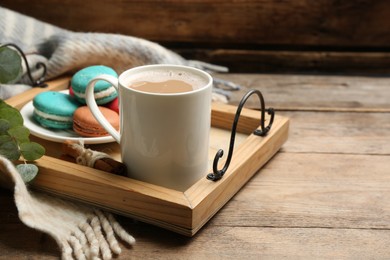 Photo of Composition with coffee and warm plaid on wooden table