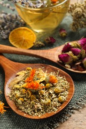 Mix of dried herbs and tea on table, closeup view