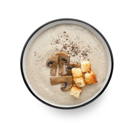 Photo of Delicious cream soup with mushrooms and croutons on white background, top view