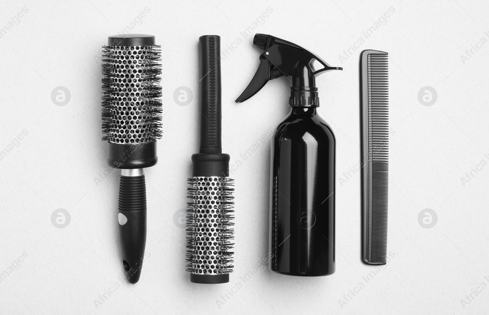 Photo of Flat lay composition with modern hair comb and brushes on white background