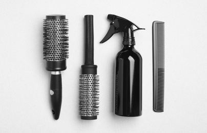 Photo of Flat lay composition with modern hair comb and brushes on white background
