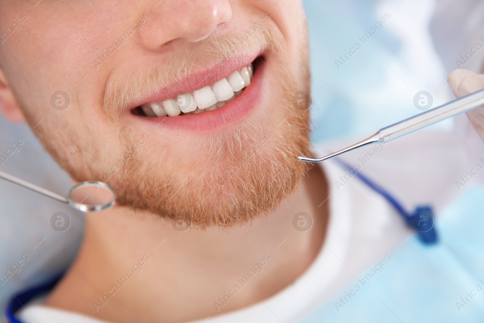 Photo of Examining patient's teeth in modern clinic, closeup. Visiting dentist